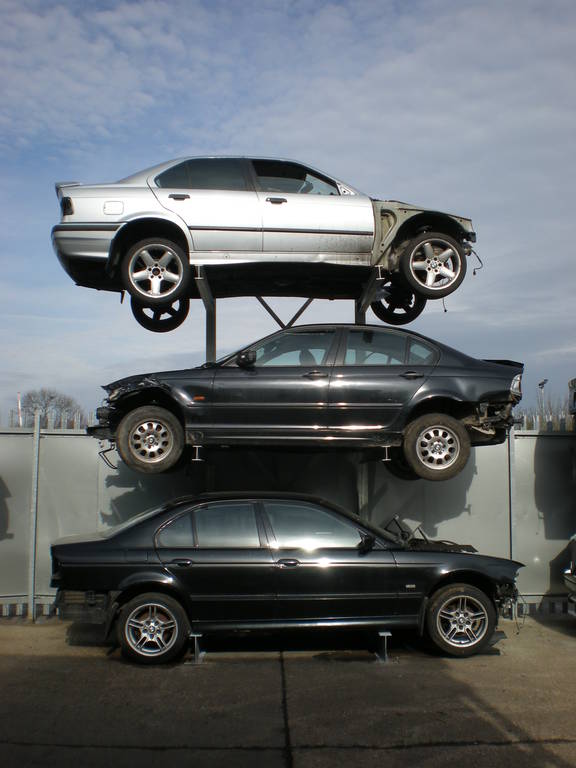 scrap-car-racking A car rack with three scrap cars on it