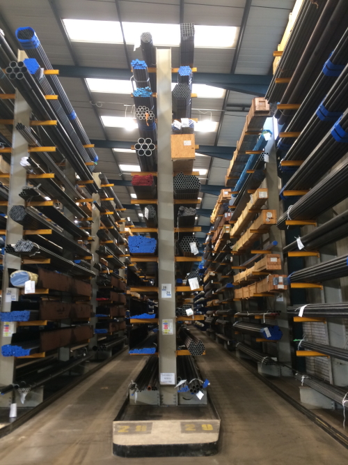 Warehouse with blue cantilever racking storing metal bar and tube on 12 levels in height